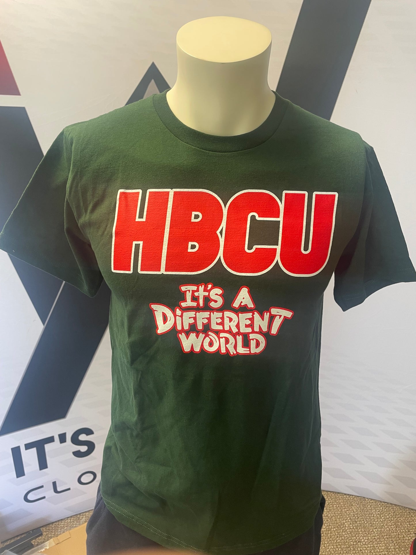 Green shirt red and white lettering