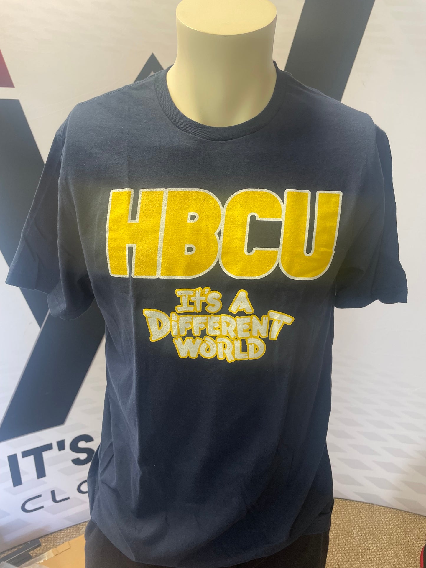 Navy blue shirt with yellow and white lettering
